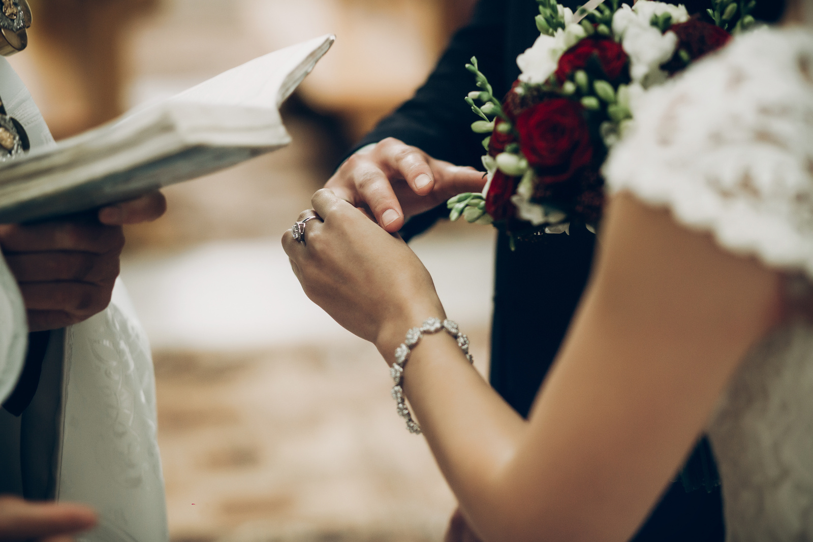 bride and groom exchanging wedding rings, putting on fingers during wedding ceremony in church. wedding couple